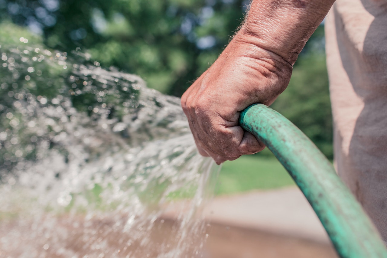 man holding a water hose