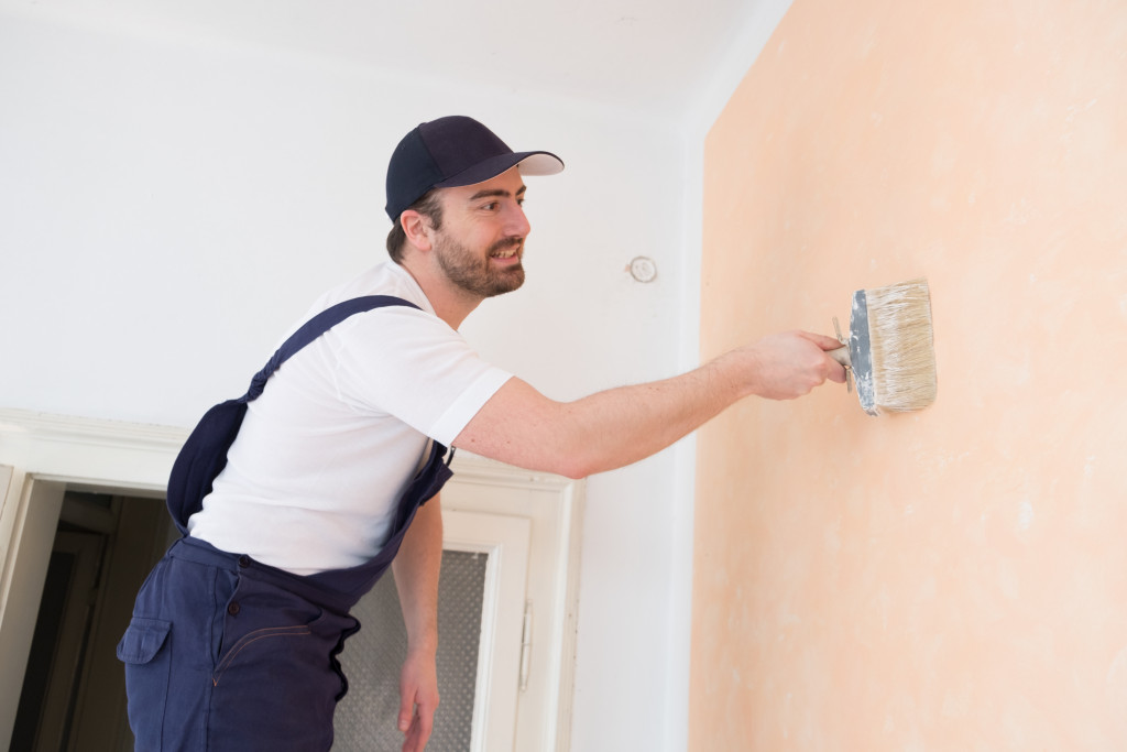 man painting house