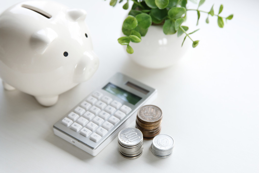 piggy a white piggy bank with coins and calculator