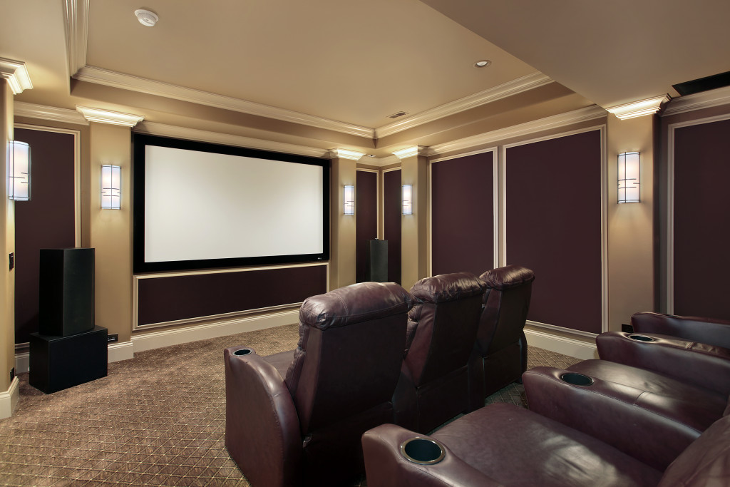 A home theater room with lounge chairs