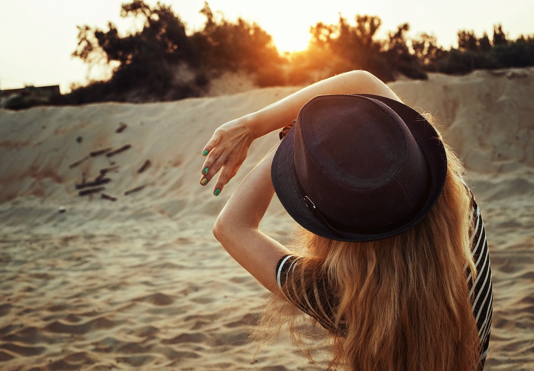 Woman shielding self from sun