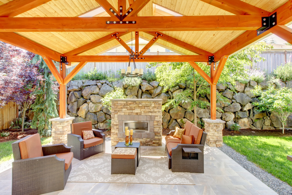 A luxurious covered patio with furniture and fireplace