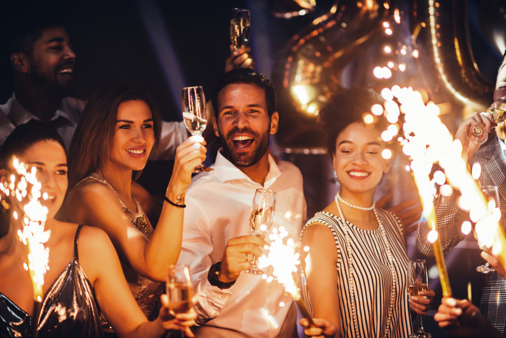 people and sparklers smiling