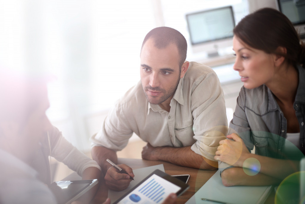 couple talking to an expert about risks in their location