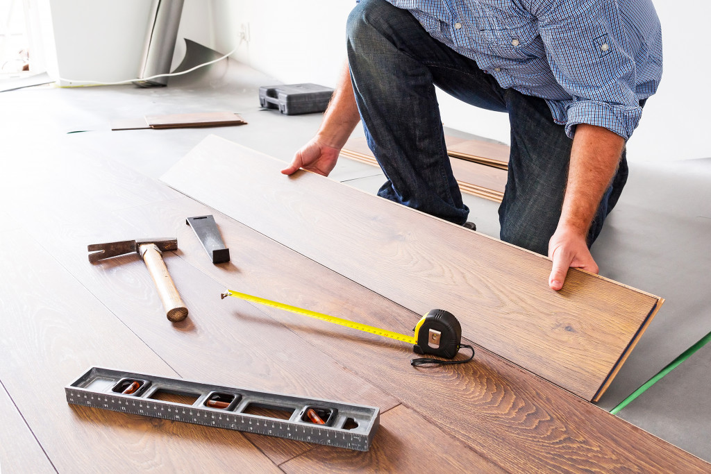 man adding new hardwood flooring to his house