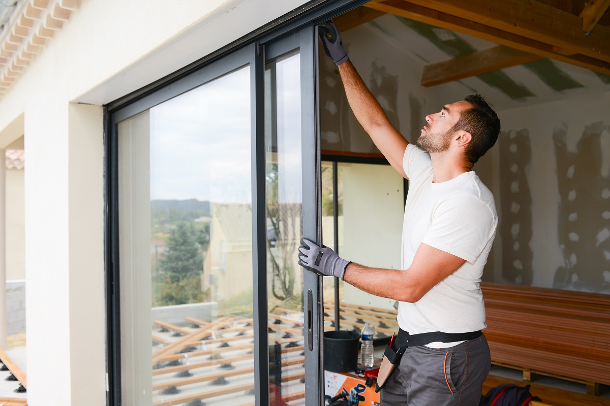 A handsome man repairing sliding windows