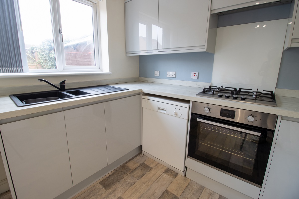 Simple kitchen renovation with modern appliances.