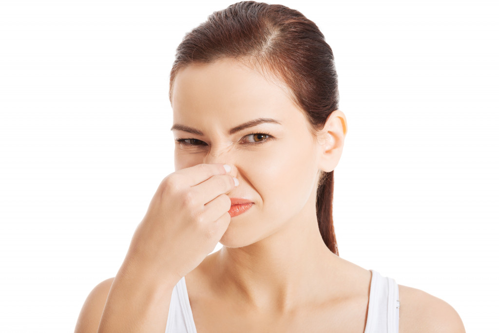 Mother covering her nose due to smell