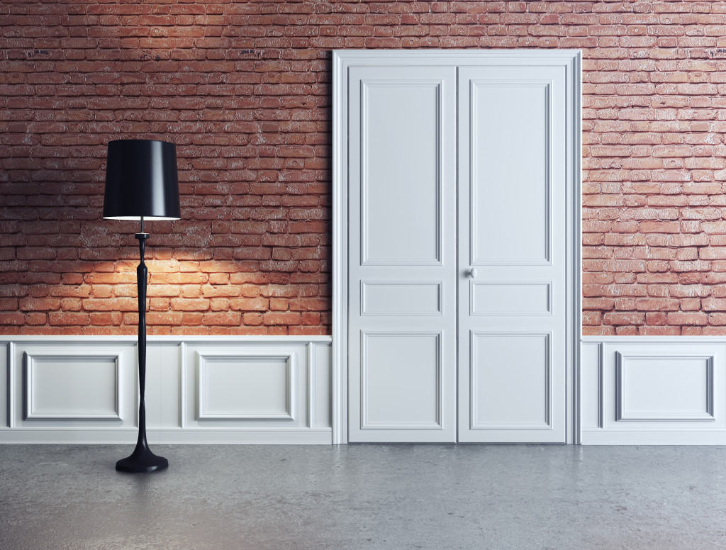 a black-colored lamp beside a white door