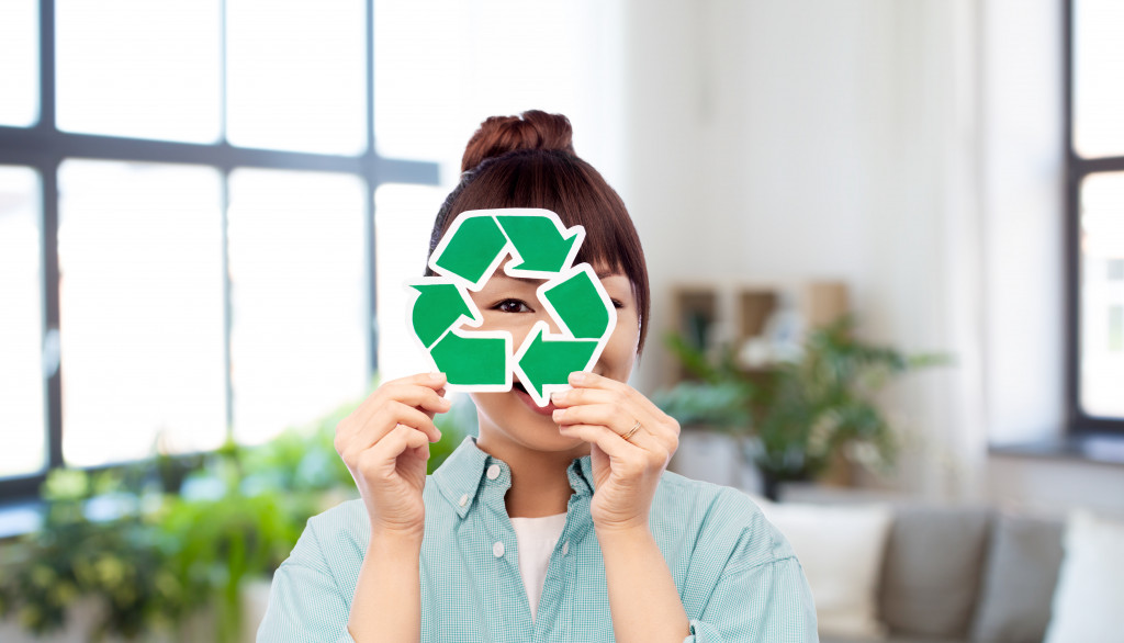 woman holding recycling sign