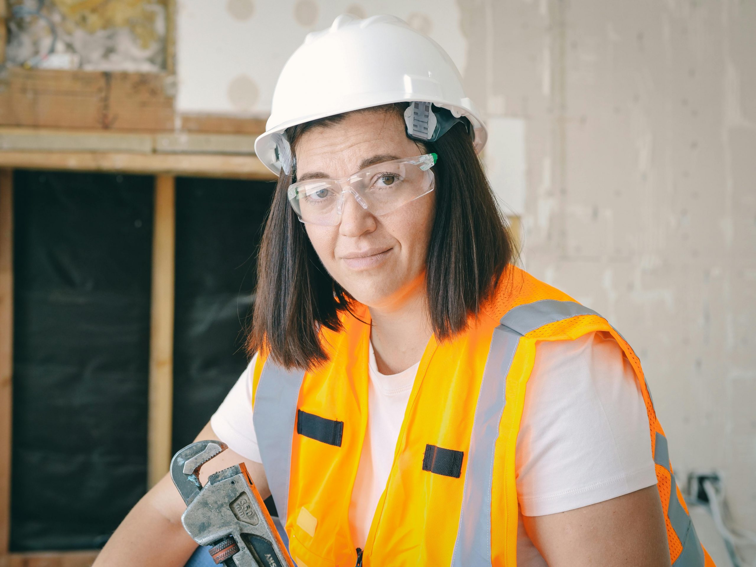 female plumber holding a wrench