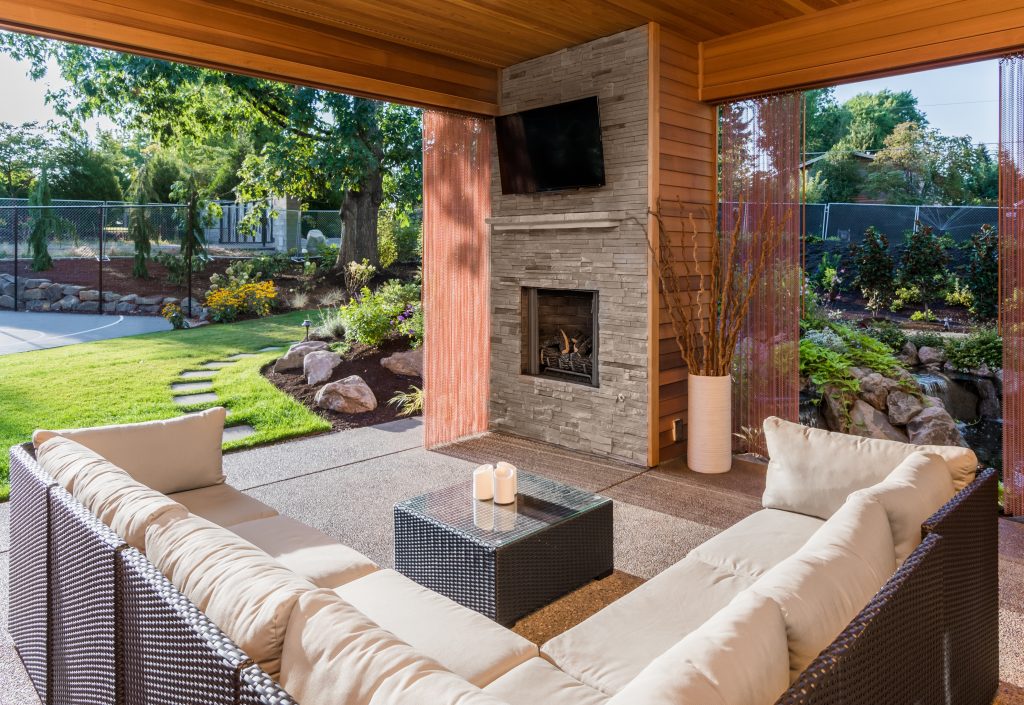 patio with couches, a fireplace, and a coffee table