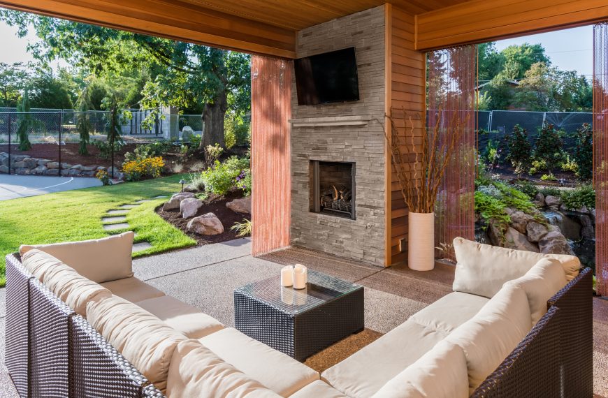 patio with couches, a fireplace, and a coffee table